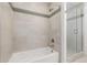 Shower featuring tiled walls with glass door and both standard and rainfall shower heads at 2824 W Parkside Pl, Denver, CO 80221