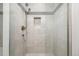 Shower featuring tiled walls with glass door and both standard and rainfall shower heads at 2824 W Parkside Pl, Denver, CO 80221