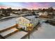Stunning aerial view of a modern home, showcasing its architecture and winter landscape setting at 4650 W 9Th Ave, Denver, CO 80204