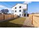 Private backyard featuring lush green grass, a wood fence, and the home's exterior at 4650 W 9Th Ave, Denver, CO 80204