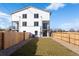 Charming backyard with a well-maintained lawn, privacy fence, and exterior view of the home at 4650 W 9Th Ave, Denver, CO 80204