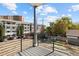 A modern balcony featuring black metal railings and an elevated view of the neighborhood on a sunny day at 4650 W 9Th Ave, Denver, CO 80204