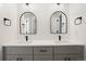 Stylish bathroom with double sinks, arched mirrors, modern fixtures, and gray cabinets at 4650 W 9Th Ave, Denver, CO 80204