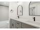Bright bathroom featuring double sinks, modern fixtures, a walk-in shower, and sleek gray cabinetry at 4650 W 9Th Ave, Denver, CO 80204