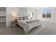 Bright bedroom with soft carpet, neutral decor, a comfortable bed, and a large window overlooking the outdoors at 4650 W 9Th Ave, Denver, CO 80204