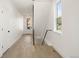 Bright hallway with wood floors and white walls, with a view of the front door and stairway at 4650 W 9Th Ave, Denver, CO 80204