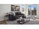 Modern living room with comfortable sofa, stylish coffee table, and sliding glass doors to a balcony at 4650 W 9Th Ave, Denver, CO 80204