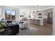 Bright, open-concept living space with hardwood floors, modern decor, and sliding glass doors to a balcony at 4650 W 9Th Ave, Denver, CO 80204