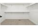 Spacious walk-in closet with ample storage, shelving, and neutral carpet flooring at 4650 W 9Th Ave, Denver, CO 80204