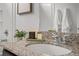 Bathroom detail featuring granite countertop, stylish faucet, and modern decor at 18645 E 54Th Pl, Denver, CO 80249