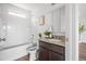 Well-lit bathroom with a shower-tub combination, granite countertop, and a modern design at 18645 E 54Th Pl, Denver, CO 80249