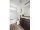 Modern bathroom features a tiled shower-tub, granite countertop vanity, and wood-look floors at 18645 E 54Th Pl, Denver, CO 80249