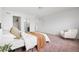 Spacious bedroom with a comfortable chair and a walk-in closet at 18645 E 54Th Pl, Denver, CO 80249