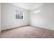 Bright, carpeted bedroom with a view of the neighborhood outside the window at 18645 E 54Th Pl, Denver, CO 80249