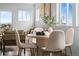 Bright dining area with a round table, plush chairs, and abundant natural light at 18645 E 54Th Pl, Denver, CO 80249