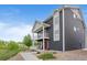 Charming two-story home boasts double balconies, well-manicured lawn, and inviting curb appeal at 18645 E 54Th Pl, Denver, CO 80249