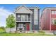 Charming two-story home with a cozy front porch and a well-manicured lawn at 18645 E 54Th Pl, Denver, CO 80249