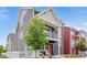 Inviting two-story home featuring a charming balcony, mature tree, and a welcoming front entrance at 18645 E 54Th Pl, Denver, CO 80249
