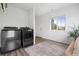 Functional laundry room equipped with modern washer and dryer, ample space, and natural light at 18645 E 54Th Pl, Denver, CO 80249