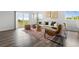 Open living area with hardwood floors, sliding glass doors, and a comfortable seating arrangement at 18645 E 54Th Pl, Denver, CO 80249