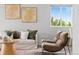 Cozy living room featuring neutral tones, modern furniture, and natural light through a large window at 18645 E 54Th Pl, Denver, CO 80249