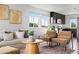 Comfortable living room featuring modern furniture, natural light, and a view of the open-concept kitchen at 18645 E 54Th Pl, Denver, CO 80249