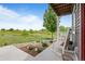Inviting porch with rocking chairs and serene views of the lush green landscape at 18645 E 54Th Pl, Denver, CO 80249