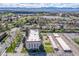 Aerial view of property featuring the building, pool, carports and green space at 7801 W 35Th Ave # 406, Wheat Ridge, CO 80033