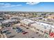 An aerial view displays an updated shopping center including ample parking and desirable storefronts at 7801 W 35Th Ave # 406, Wheat Ridge, CO 80033