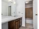 Bathroom with a single sink vanity, well-lit mirror and a combined bathtub and shower at 7801 W 35Th Ave # 406, Wheat Ridge, CO 80033