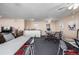 Well-lit common area with tables, chairs, bar seating and entertainment for residents and guests at 7801 W 35Th Ave # 406, Wheat Ridge, CO 80033