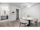 Inviting dining area featuring a modern table setting, seamless flow into the kitchen, and neutral decor at 7801 W 35Th Ave # 406, Wheat Ridge, CO 80033