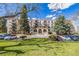 Inviting condo building with well-maintained lawns, lush trees, and ample parking for residents and guests at 7801 W 35Th Ave # 406, Wheat Ridge, CO 80033