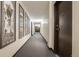 Hallway featuring neutral walls, gray carpet, and decorative pictures for a modern feel at 7801 W 35Th Ave # 406, Wheat Ridge, CO 80033