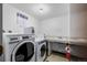 Laundry room featuring a washing machine, dryer, and sink with white walls and light overhead at 7801 W 35Th Ave # 406, Wheat Ridge, CO 80033