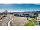 Aerial view of a neighborhood with walking paths and green spaces under a blue sky at 9756 Ash Ln, Thornton, CO 80229