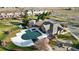 Aerial view showcasing a covered community pool, clubhouse, and nearby playground at 9756 Ash Ln, Thornton, CO 80229