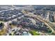 Community aerial view showing numerous townhomes, a recreational center, and green spaces at 9756 Ash Ln, Thornton, CO 80229