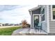 Back patio with two chairs overlooking a green space and neighboring homes at 9756 Ash Ln, Thornton, CO 80229