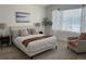 Bright bedroom featuring a patterned bedspread and a large window for ample natural light at 9756 Ash Ln, Thornton, CO 80229