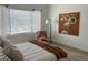 Serene bedroom featuring a cozy chair and a large window with natural light at 9756 Ash Ln, Thornton, CO 80229