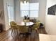 Charming dining room area with wood table and stylish chairs, illuminated by modern lighting at 9756 Ash Ln, Thornton, CO 80229