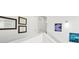 Bright hallway with white walls, framed diplomas, and abstract art leading to other rooms at 9756 Ash Ln, Thornton, CO 80229