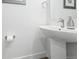 Stylish powder room featuring a modern sink, mirror, and sleek fixtures at 9756 Ash Ln, Thornton, CO 80229