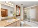 Bathroom featuring a tub with glass shower door, a single sink, and a toilet at 7115 Parkwood Ln, Castle Pines, CO 80108