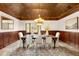 Elegant dining room boasts a decorative ceiling, paneled walls, and a large window view at 7115 Parkwood Ln, Castle Pines, CO 80108