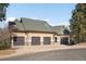 Spacious four car attached garage with a driveway, offering ample parking and storage space at 7115 Parkwood Ln, Castle Pines, CO 80108