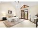 Bright and airy main bedroom with vaulted ceilings, balcony, and seating area at 7115 Parkwood Ln, Castle Pines, CO 80108