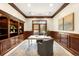 Home office with custom built-ins, paneled walls, and a bright window at 7115 Parkwood Ln, Castle Pines, CO 80108