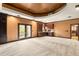 Bright and spacious recreation room with a custom wet bar, balcony access, and recessed lighting at 7115 Parkwood Ln, Castle Pines, CO 80108